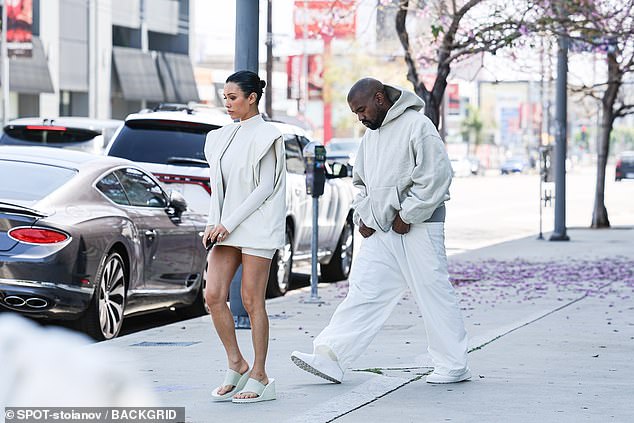 Kanye looked somber as he strolled alongside his wife.