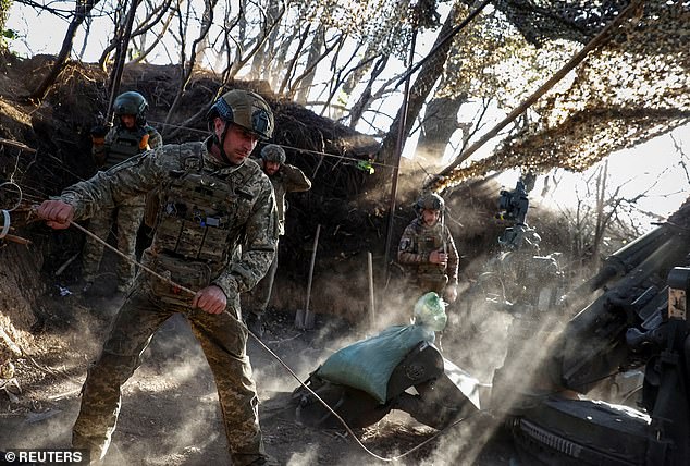 Servicemen of the 1148th independent artillery brigade of the Ukrainian air assault troops fire an M777 howitzer at Russian troops on April 20.