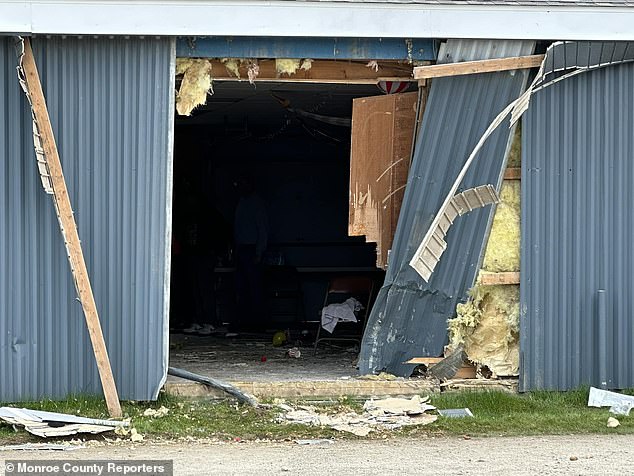 Horrifying images showed balloons and party glasses scattered after a drunk driver crashed a children's birthday party, killing two young siblings and leaving at least nine victims fighting for their lives (Pictured: Broken wall at the scene)