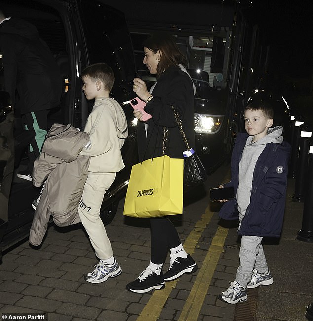 Her children wore comfortable tracksuits as they followed their mother to the car.
