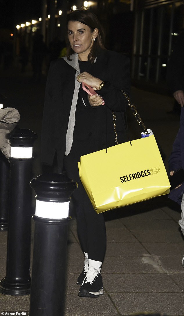 She had clearly enjoyed her shopping trip when she left with a large yellow bag from Selfridges.
