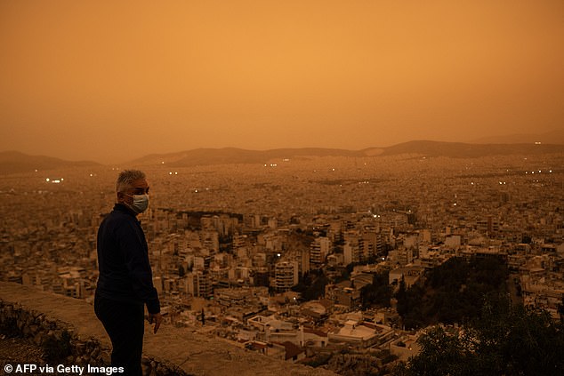 The city of Athens seen from Tourkovounia Hill after it turned orange thanks to dust from the Sahara desert