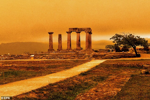 The Temple of Apollo in Corinth, Greece, looking orange after dust blew towards the southern coast