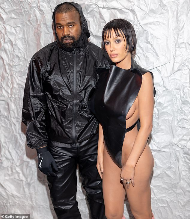 Kanye is pictured with his wife Bianca Censori attending Milan Fashion Week this February.