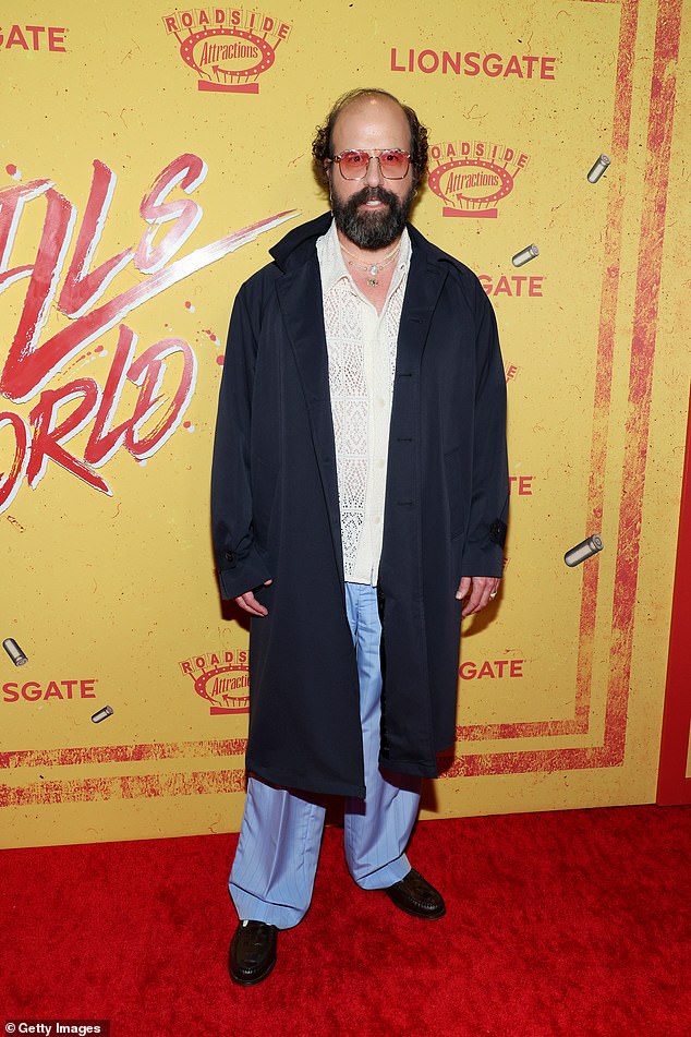 Brett Gelman, 47, showed off his signature style. The Fleabag star donned a long black coat over a white lace shirt and blue silk pants.