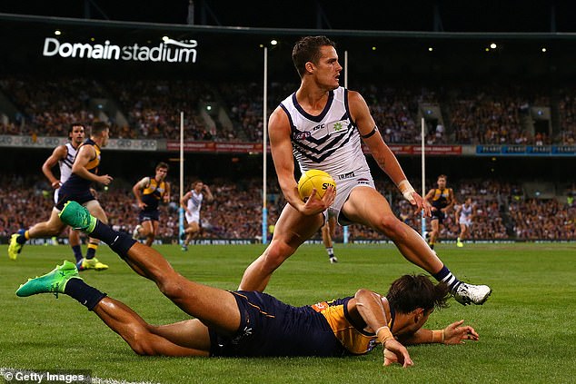 Balic (centre pictured playing for Fremantle against West Coast) announced his immediate retirement from the sport in August 2018.