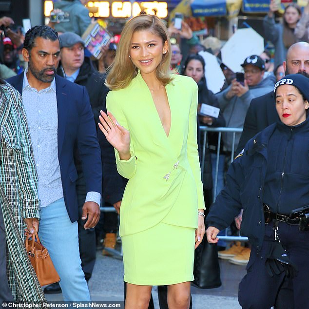 She was seen leaving the studios in an elegant lime green suit.