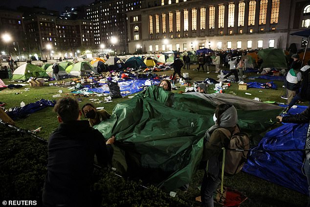 Students tear down tents before midnight, the deadline set by Columbia's president for student protesters to leave the protest camp.