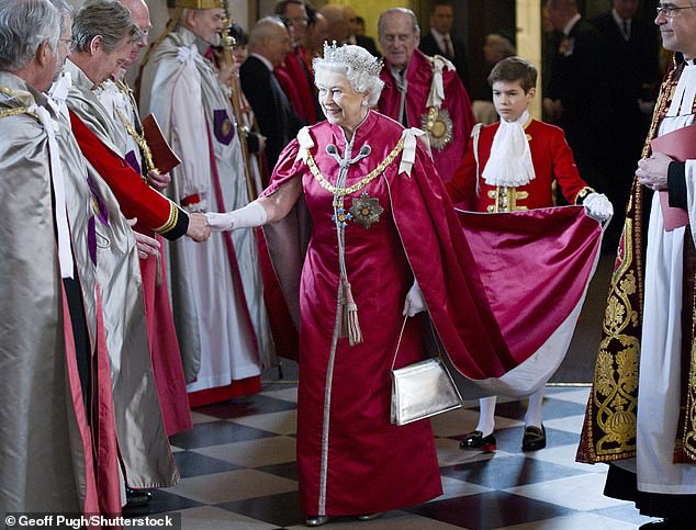 Queen Elizabeth II's dress was held by Arthur Chatto (son of Lady Sarah and Daniel Chatto) Service for the Order of the British Empire, St Paul's Cathedral in 2012.