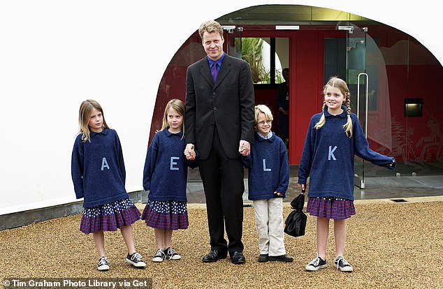 Earl Spencer, brother of the Princess of Wales, with his children at the opening of the Princess of Wales's memorial playground in Kensington Gardens in London. From left to right: Amelia, Eliza, Louis [viscount Althorp] and kitten