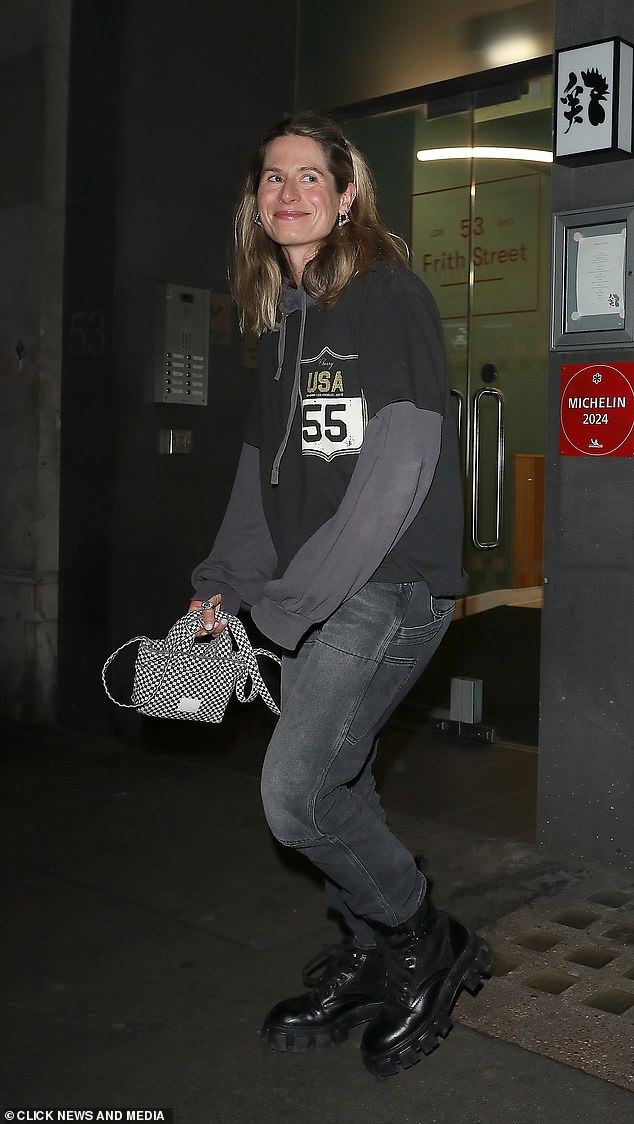 Cherry put on an edgy display in an oversized hoodie with a distressed t-shirt, baggy jeans, and chunky boots.