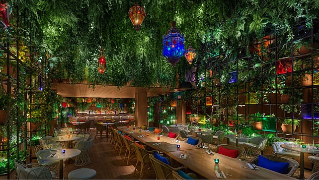 The gorgeous rooftop bar is decorated with foliage and fairy lights.