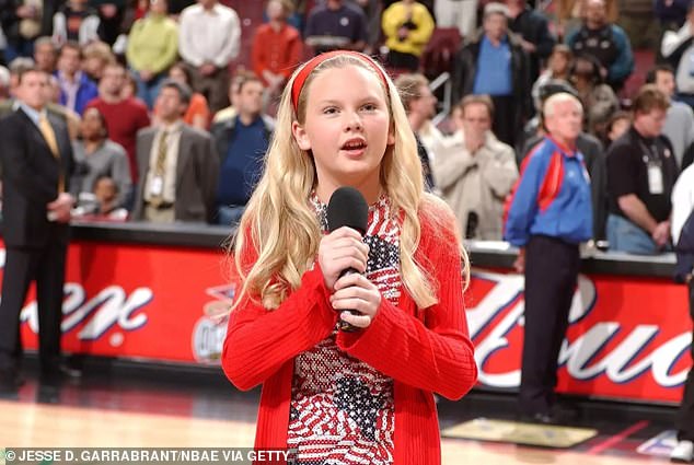 He looked back at the yearbooks and revealed that Taylor said in first grade that she wanted to be a stockbroker, and in second grade she had switched to being a singer;  Taylor photographed singing the national anthem in April 2002.