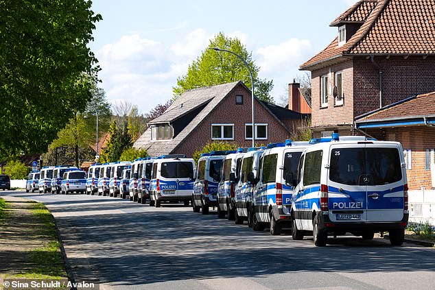 Numerous emergency vehicles are parked along a road in the town of Elm, Lower Saxony, while hundreds of police and firefighters desperately try to locate the boy.