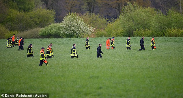 Police and firefighters comb a field for missing six-year-old Arian in Lower Saxony, Germany