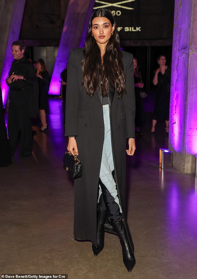 Model Neelam looked chic in a long black coat which she layered over a jumpsuit and skinny blue jeans.