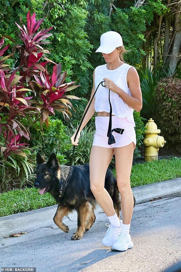 She adopted her new furry friend in February and takes him for walks frequently to stay in shape for the runway.