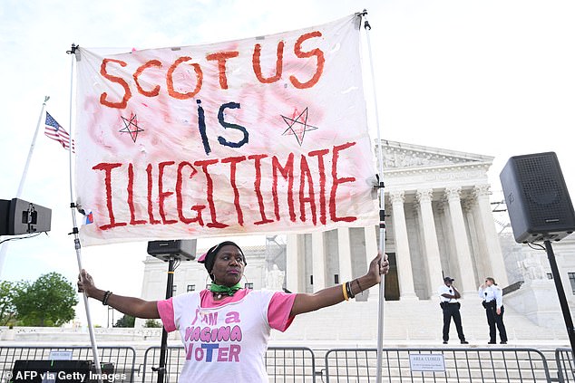 Abortion rights activist stands in front of the Supreme Court Wednesday morning.
