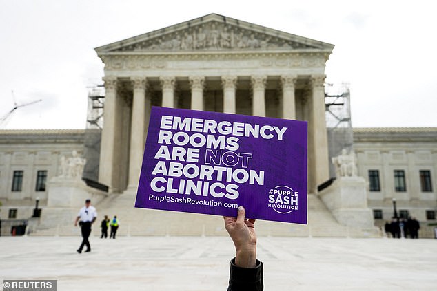 An anti-abortion activist with a sign before oral arguments on Idaho's near-total abortion ban.