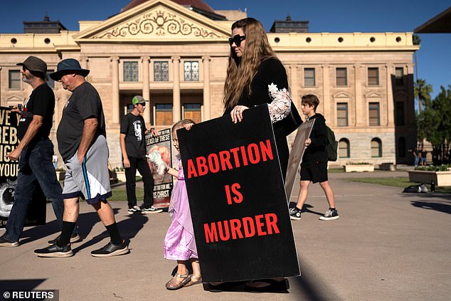 Anti-abortion rights protesters outside the Arizona State Capitol before the House voted to repeal the 1864 law banning abortion.