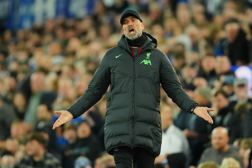Liverpool manager Jurgen Klopp shouts and extends his arms in a questioning gesture during a match.