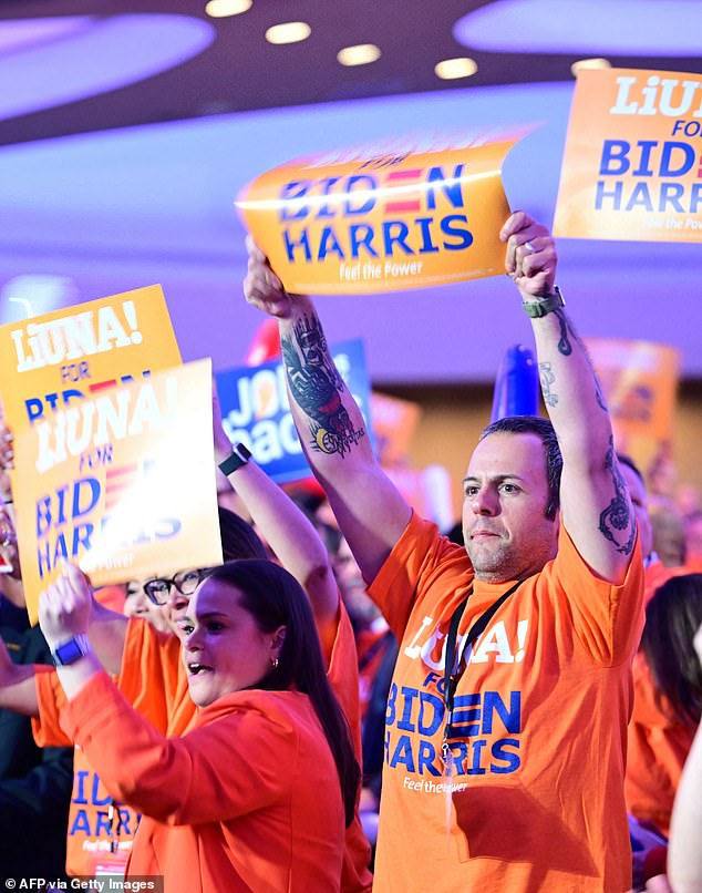 Union members wear Biden-Harris campaign t-shirts and wave signs before U.S. President Joe Biden speaks at the North American Construction Unions 2024 Legislative Conference.