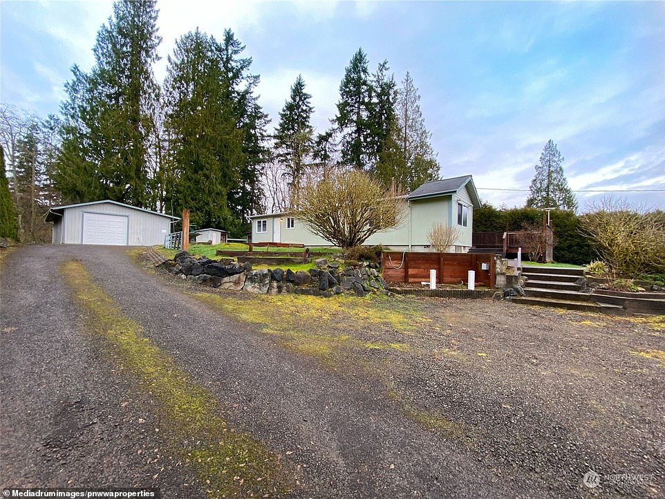 The front of the property offers a wide driveway leading to a garage, which comes in handy during bad weather.