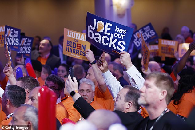 NABTU members hold signs in support of President Joe Biden after the union offered its endorsement to the Democratic president on Wednesday.