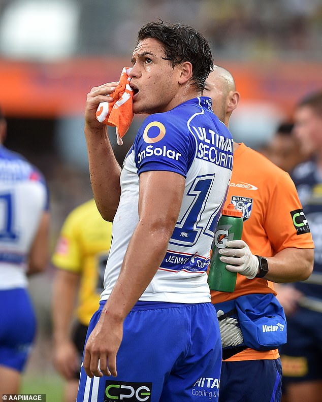The 22-year-old (pictured playing for the Bulldogs) was allegedly forced to grab his teammates one after another for 30 seconds at a time, and other players were allegedly told not to give in when he showed signs of distress .