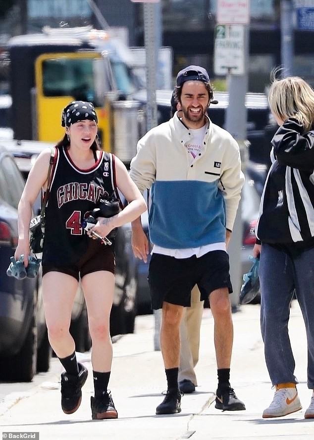 Alex sported an 'A24' sweater and black shorts.