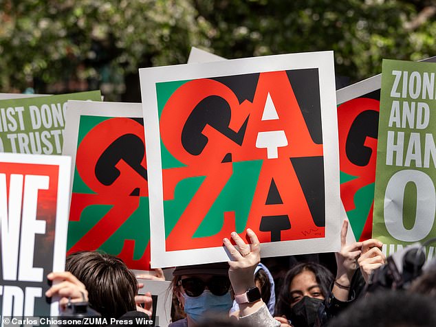 A New York University student holds a sign about Gaza during a demonstration in Washington Square Park to protest the arrests made yesterday during the Gaza Solidarity Camp.