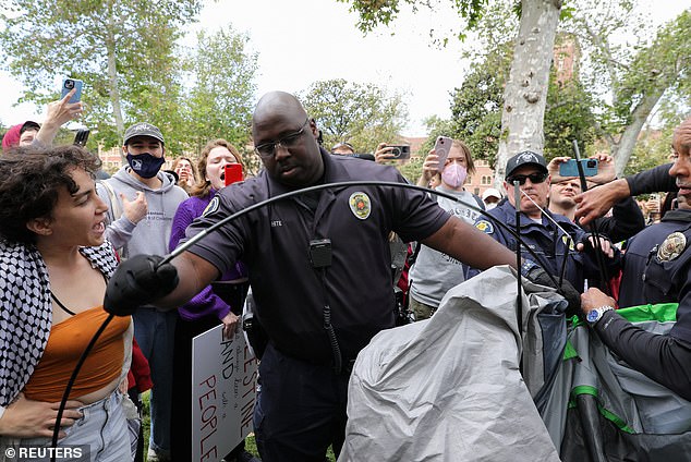 USC security officers attempt to disperse pro-Palestinian protesters and tear down tents