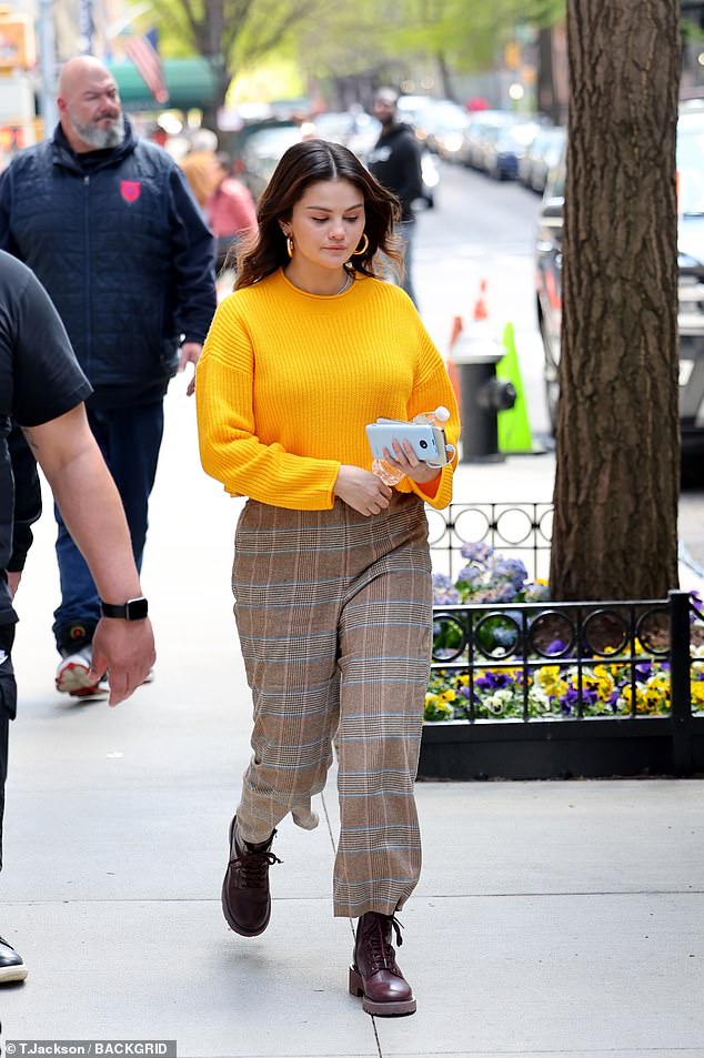 The actress, 31, was seen sporting a bold yellow knit sweater with brown plaid shorts as she did on the Upper West Side set.