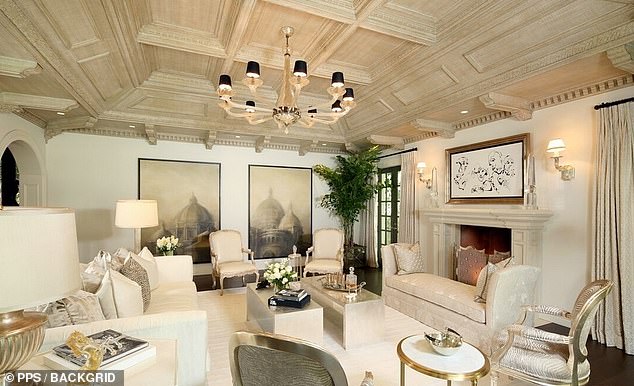 Your family room has a fireplace, dentil molding, and coffered ceiling.