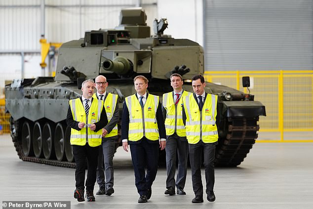 Shapps (pictured centre, in front of a new Challenger 3 tank) insisted the Government was activating the UK's defense industrial base and 