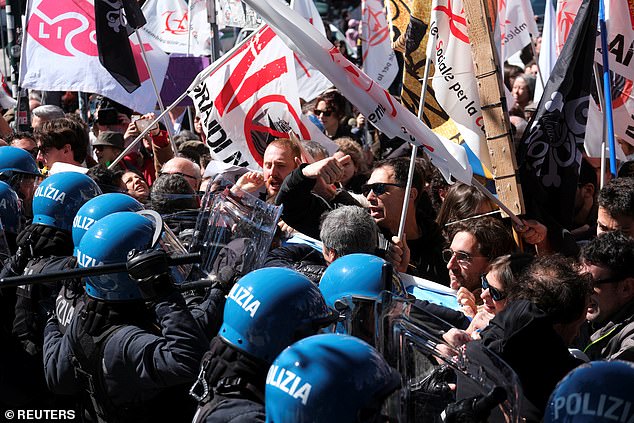 People clash with police as they protest against the introduction of the tourist and registration fee in Venice, Italy, on April 25, 2024.