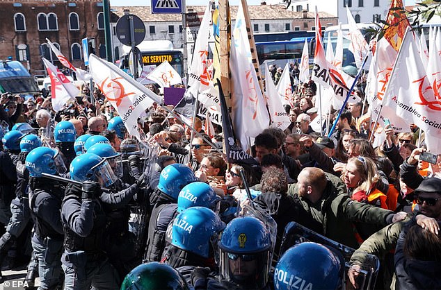 Members of social centers confront police officers during a demonstration in Piazzale Roma against the introduction of a city entrance fee for day-trippers, in Venice, April 25.