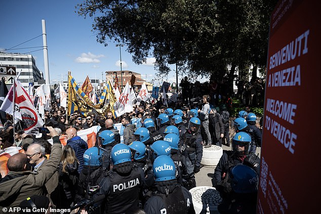 Protesters confront riot police officers during a demonstration in Venice on April 25.