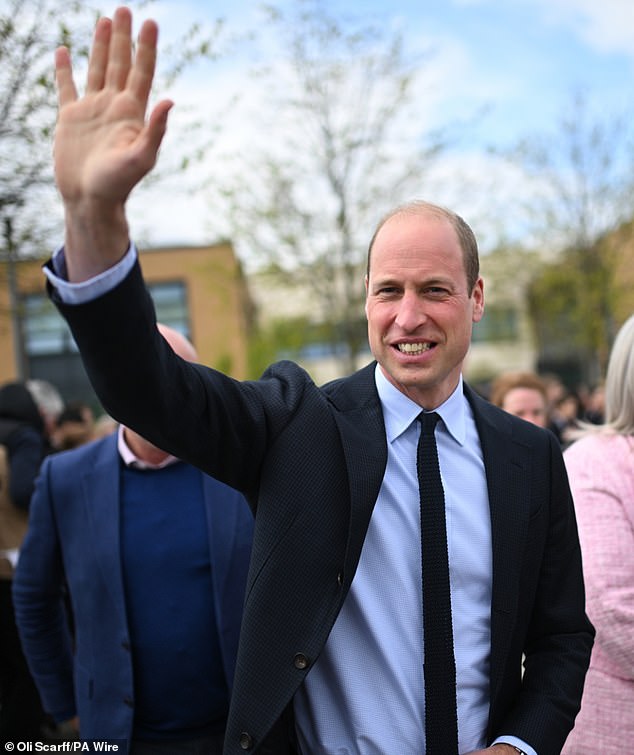 Prince William greets a crowd of royal fans as he visits a school in Sandwell today