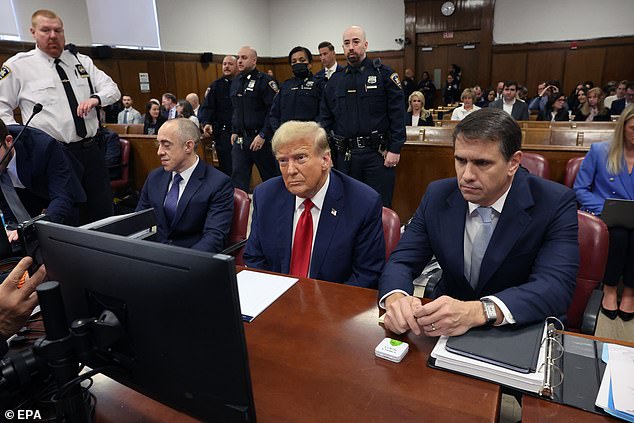 Former President Donald Trump sits between his lawyers Emil Bove (left) and Todd Blanche.