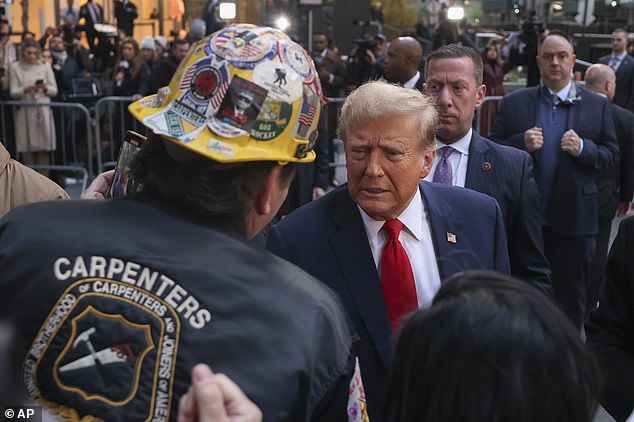 Before heading to Manhattan Criminal Court on Thursday morning, Donald Trump stopped to greet hundreds of union workers and sign MAGA hats.