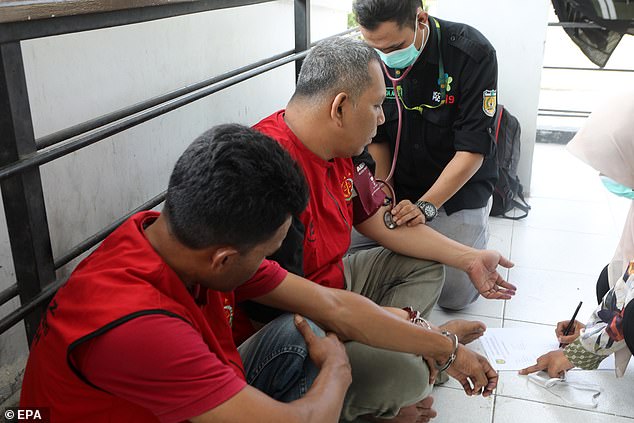 An Acehnese man undergoes a medical check-up before being flogged for violating Sharia law.