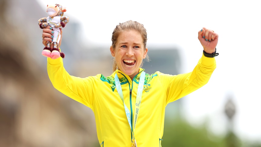 Emotional Australian marathon runner Jess Stenson smiles as she wears a gold medal around her neck. 