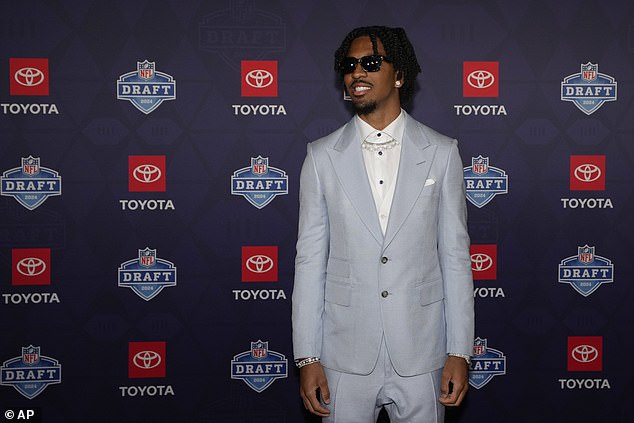 LSU quarterback Jayden Daniels poses on the red carpet before the first round of the draft.