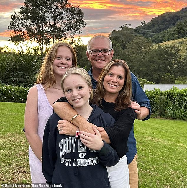Morrison is seen with his wife Jenny and daughters Lily and Abbey.