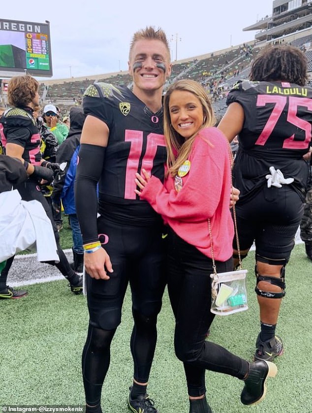 Nix and his wife, Izzy, are seen on the sidelines of an Oregon game.  The couple met in Auburn.