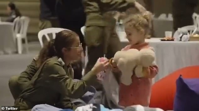 Abigail is seen with an IDF soldier shortly after her release by Hamas in November.