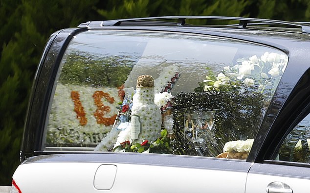 The funeral car was decorated with flowers for George's service today.