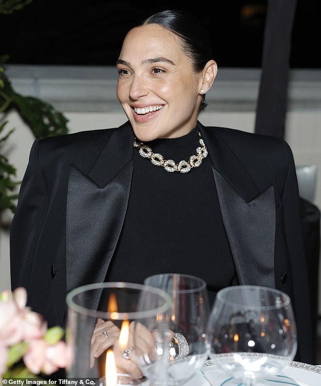 Gal brought back memories of old Hollywood, slicking her dark hair back and accessorizing it with a necklace and bracelets over her sleek black dress.