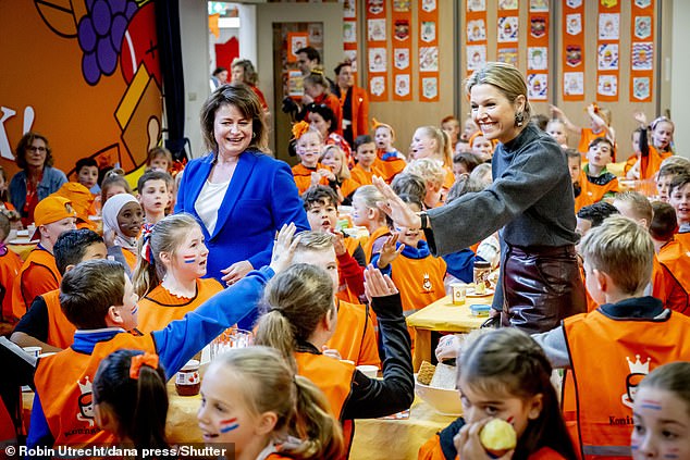 The Dutch royal, 52, appeared to have an exquisite time as she high-fived and chatted with school students.